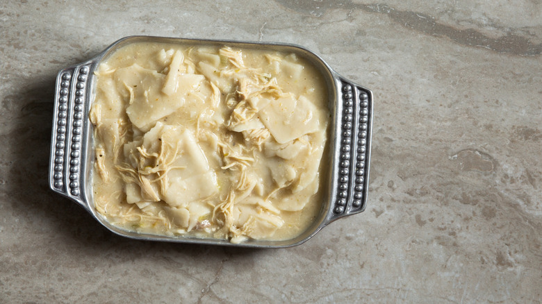 A casserole dish filled with chicken and dumplings