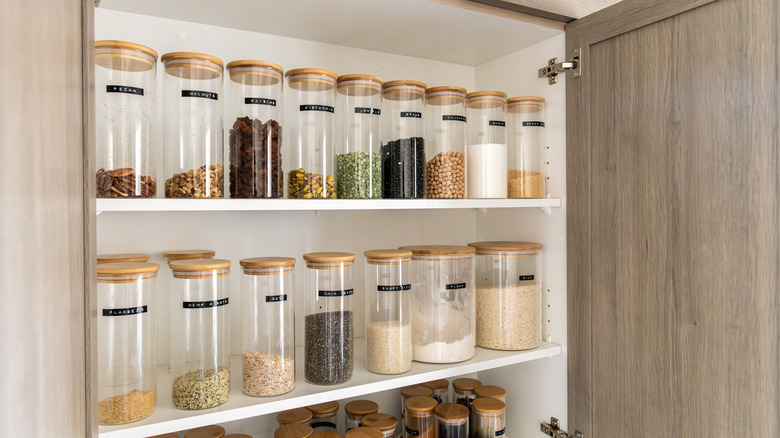 Rows of spices displayed in a spice cabinet