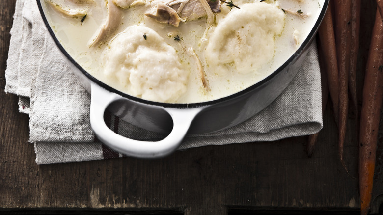 A Dutch oven filled with chicken and dumplings