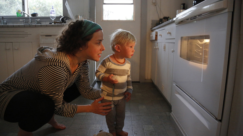 Parent and child looking into an oven