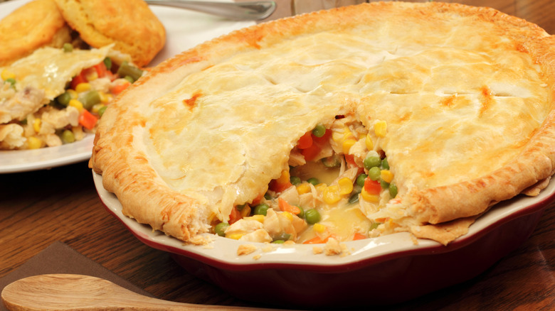 A completed chicken pot pie with a piece cut out of it