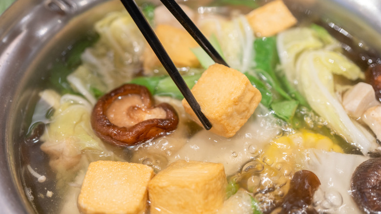 Close-up of tofu in water with vegetables