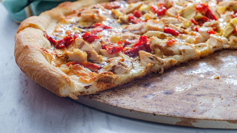 pizza cut with baking stone underneath