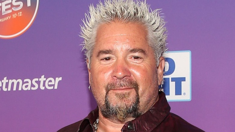 guy fieri staring at camera smirking