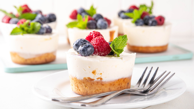 Mini cheesecakes with blueberries and raspberries on a plate