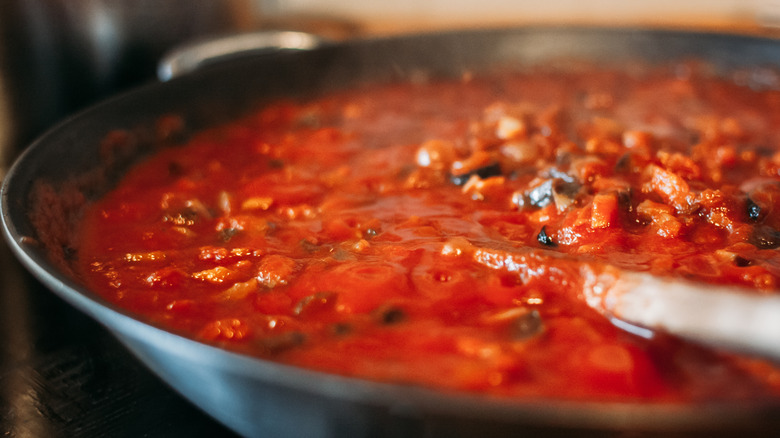 Homemade tomato sauce simmering in a pan