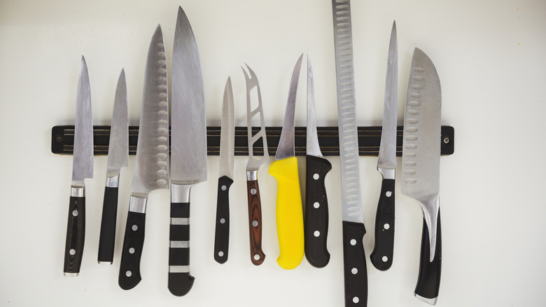 Knives hanging on a magnetic knife strip