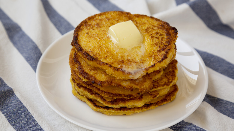 stack of homemade cornmeal johnnycakes topped with butter