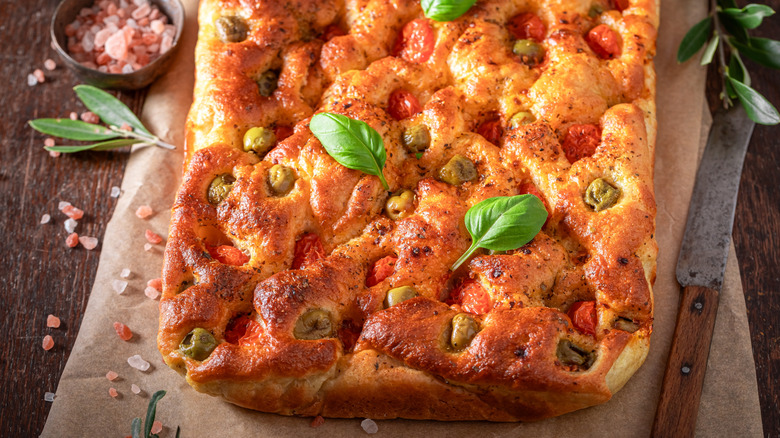 Freshly made focaccia topped with basil leaves