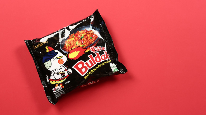 A package of Buldak ramen against a red background