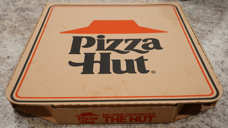 A close-up of a phone screen displaying the Pizza Hut logo.