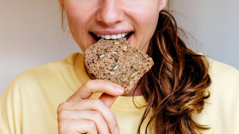 Woman with bread in mouth