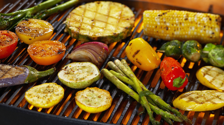 A mixture of ingredients cooking on a grill.