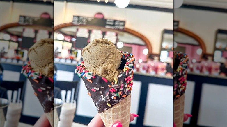 Aglamesis Bros. inside with person holding ice cream cone