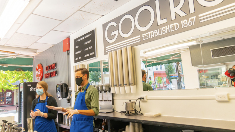 Goolrick's Pharmacy inside with two workers wearing masks