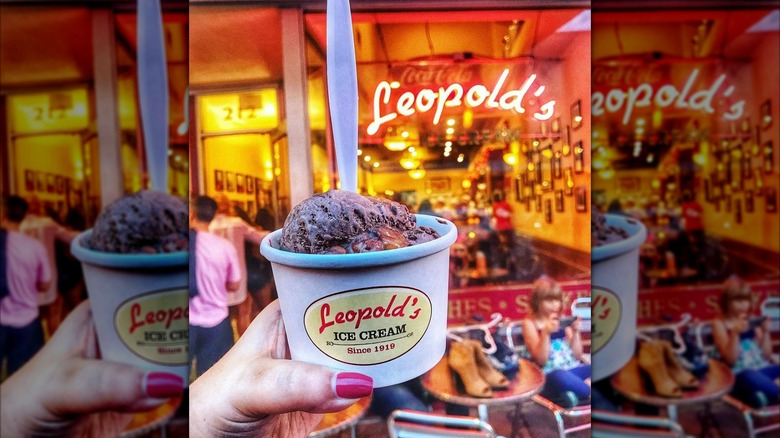 Leopold's Ice Cream with person holding ice cream in front of sign