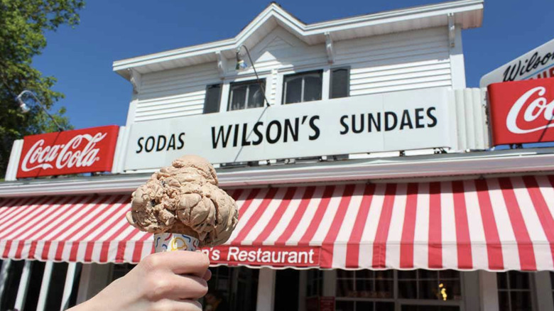 Wilson's Restaurant & Ice Cream Parlor outside with person holding ice cream