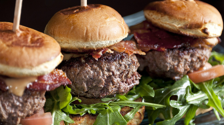 Three kobe beef sliders served on a bed of arugula