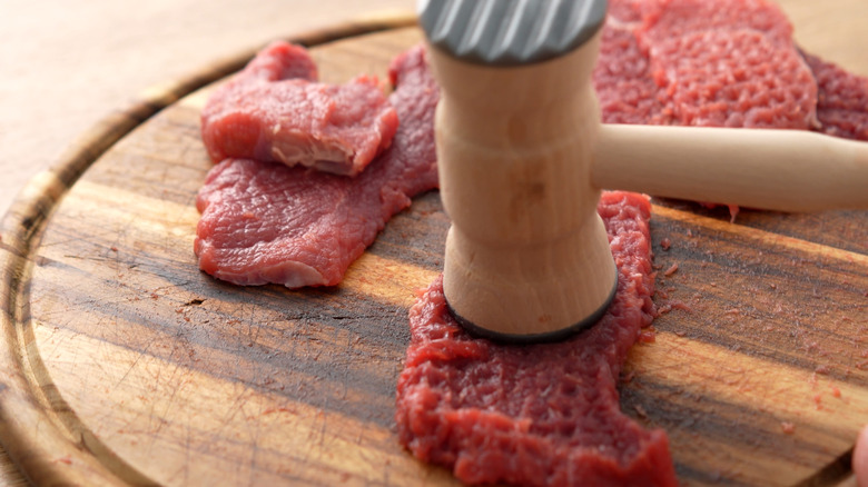 steak being pounded with a meat tenderizer