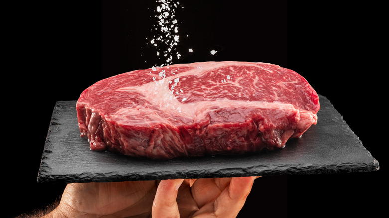 hand salting steak