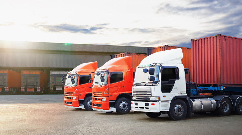 Three trucks at a distribution center.