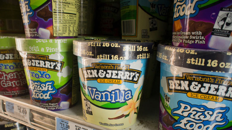 A shelf stacked with different flavors of Ben & Jerry's Ice Cream at a grocery store