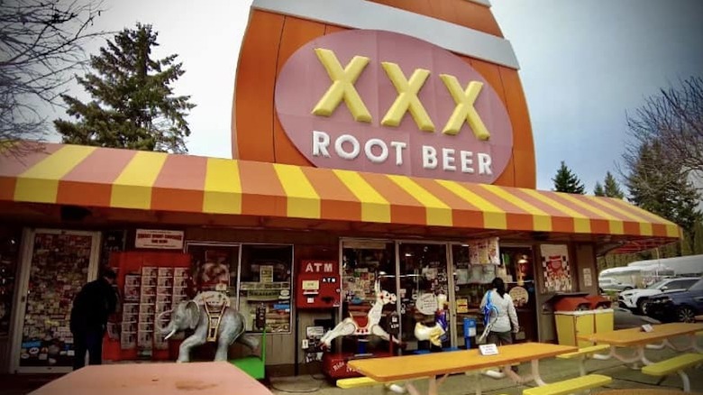 Front shot of the old XXX Root Beer shop with picnic tables in the front