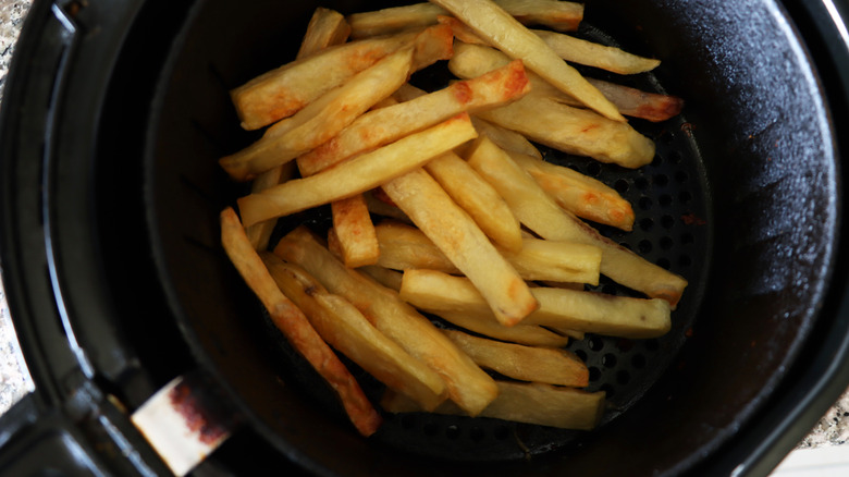 french fries in an air fryer basket