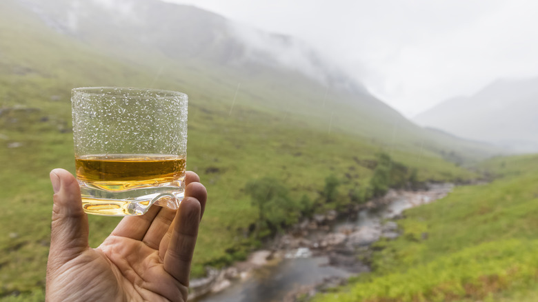 Drinking Scotch whisky in Glencoe, Scotland