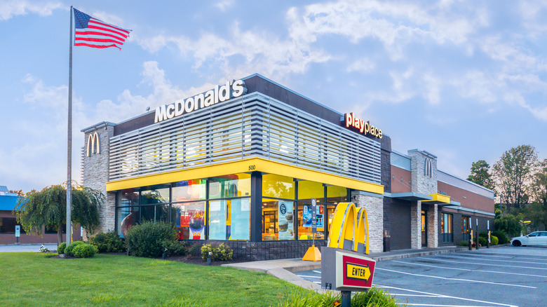 modern architecture mcdonalds restaurant with american flag flying beside it