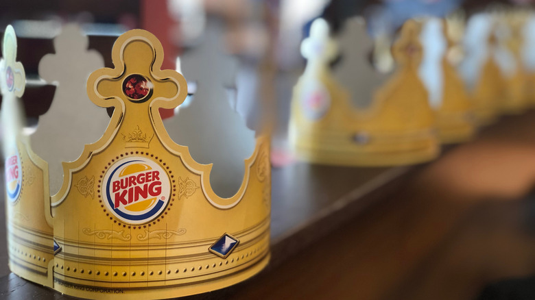 Paper Burger King crowns lines up on a table