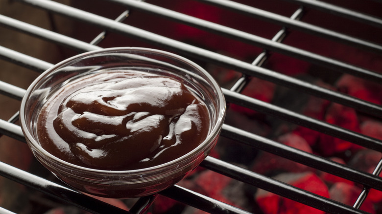 BBQ sauce bowl on a grill