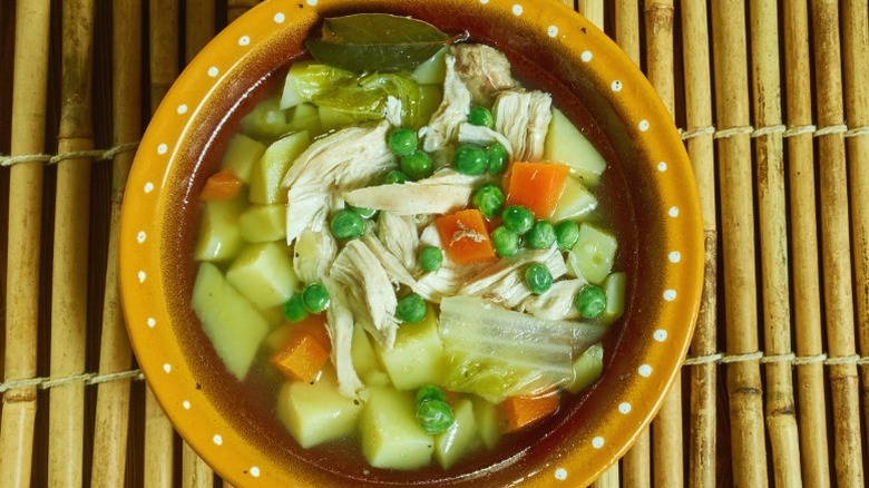 bowl of booyah stew on a bamboo mat