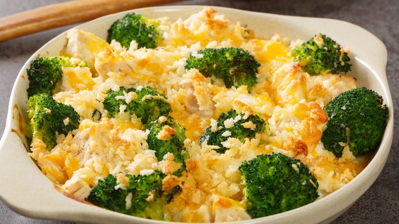 Broccoli in a baking pan topped with cheese and breadcrumbs