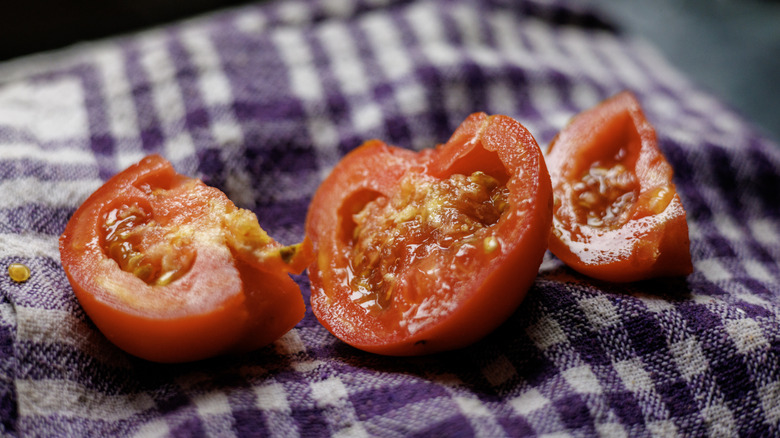 Chunks of fresh tomato on a purple gingham towel