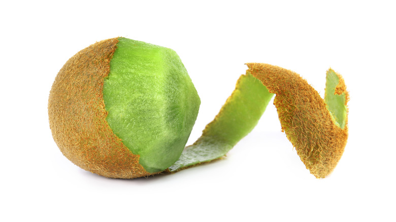 A kiwi being peeled