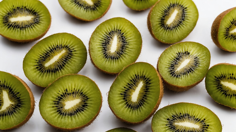 halves of kiwis on a white background