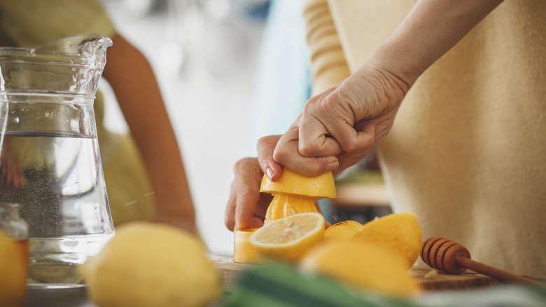 Hands juicing lemon