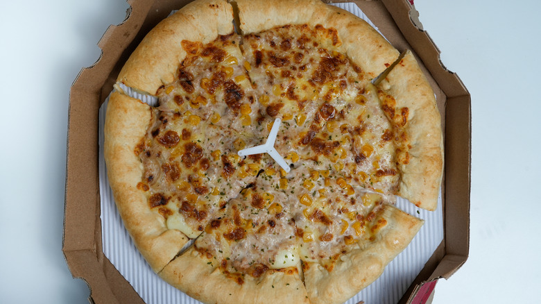 A pizza saver in the middle of a pizza