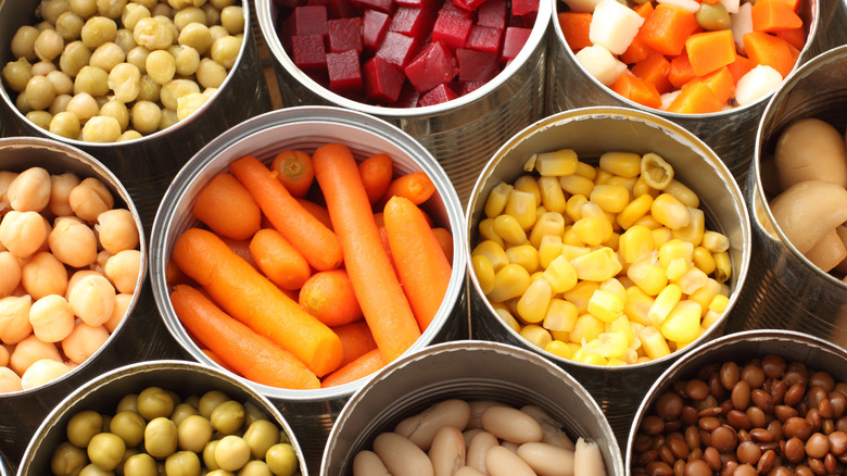 an assortment of opened cans of vegetables and beans