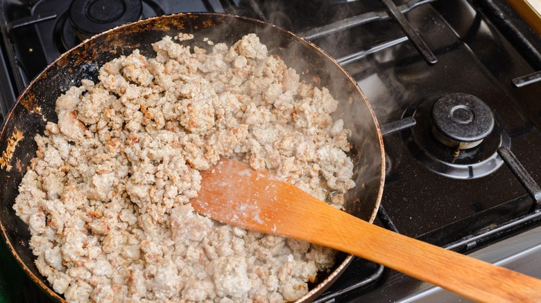 Meat browning in a pan.