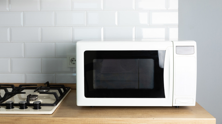 a white microwave sitting on a kitchen counter