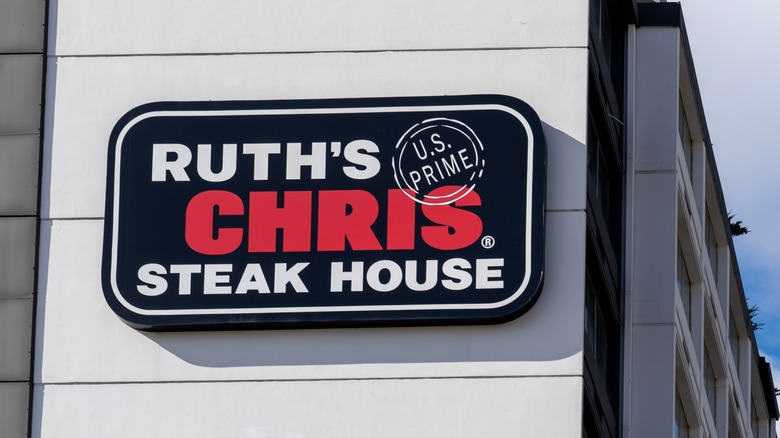 A Ruth's Chris Steak House sign on the site of a white building