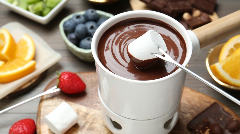 Dipping marshmallow in chocolate fondue