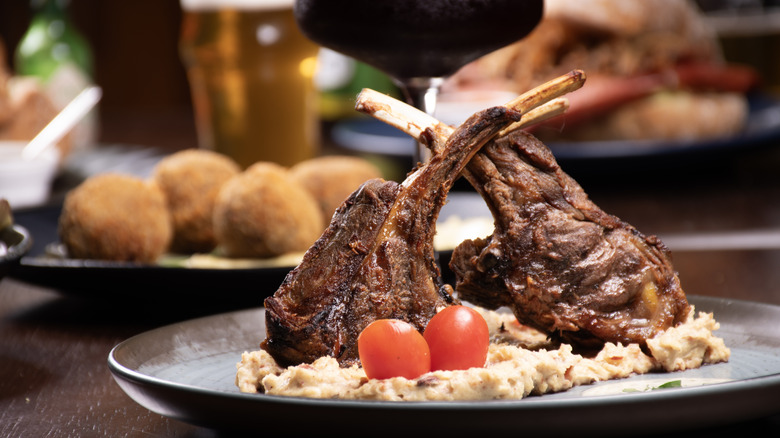 restaurant steak dish with other food in background