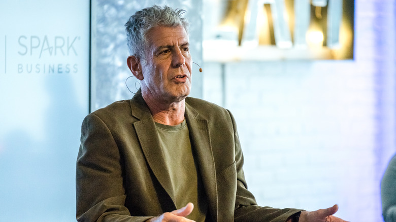 Anthony Bourdain speaking with a microphone