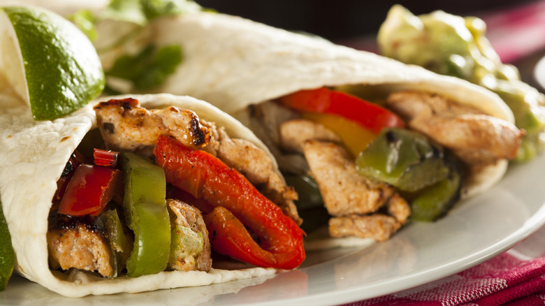 Two fajitas with chicken and peppers