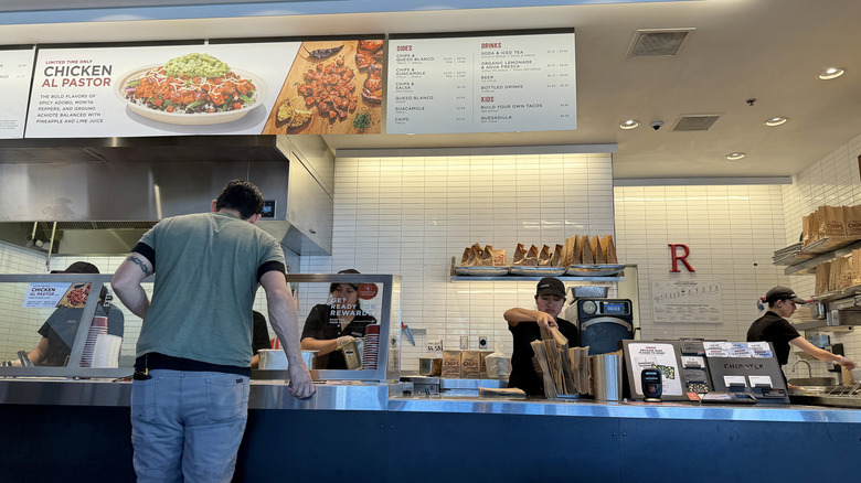 Customer orders at Chipotle counter