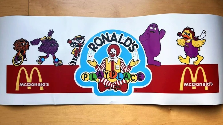 A sign for Ronald's PlayPlace featuring many McDonald's characters