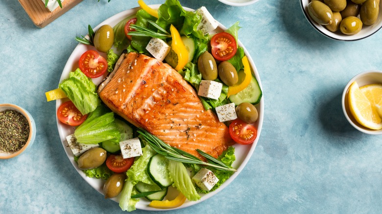 Bowl of vegetables and salmon.